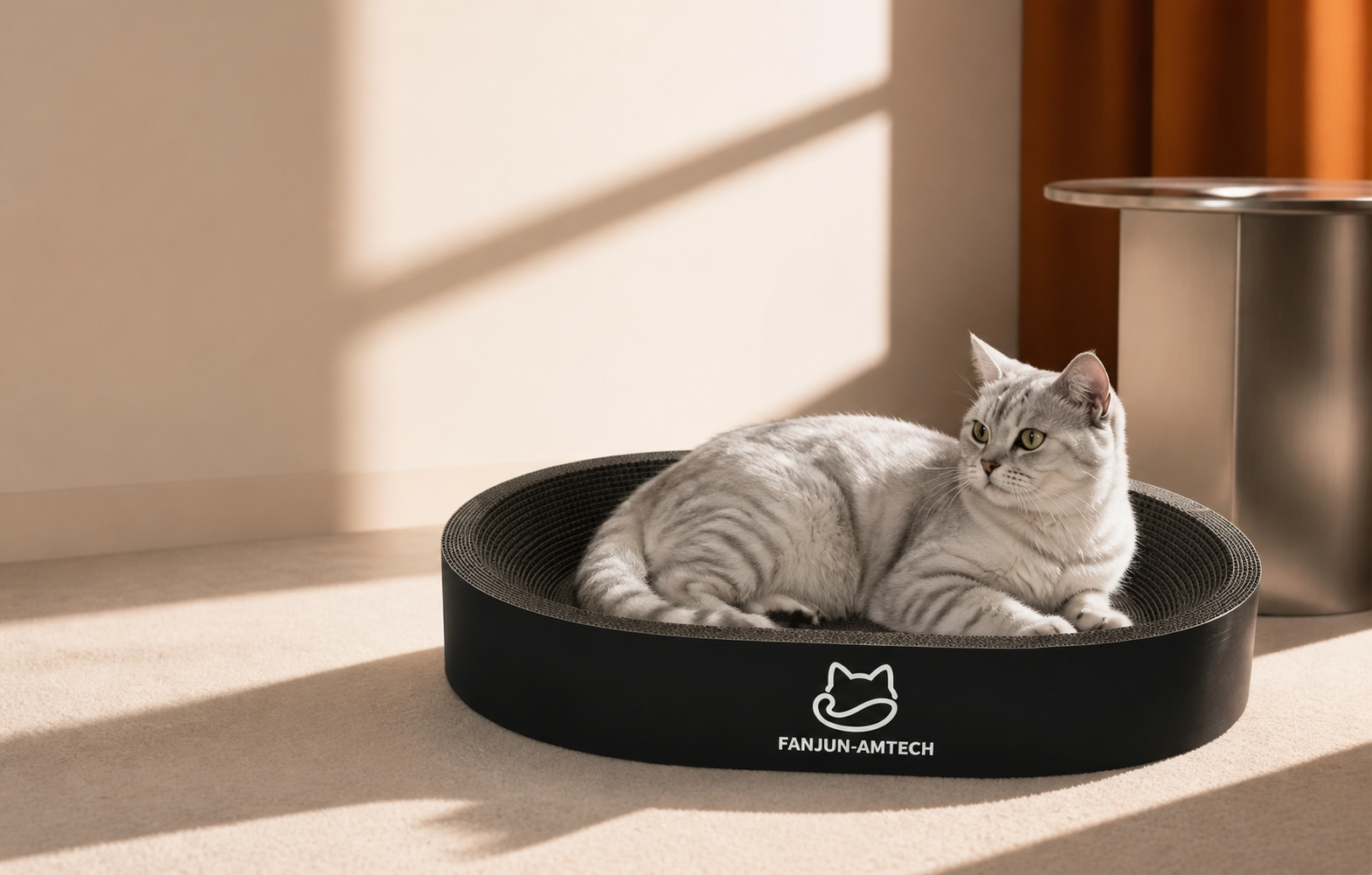 Silver tabby cat resting in a black FANJUN-AMTECH oval scratcher in a sunlit interior